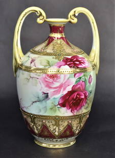 Nippon Double Handled Vase: With floral decorations. With gold and jewel highlights. Marked. 11" H. Good Condition.