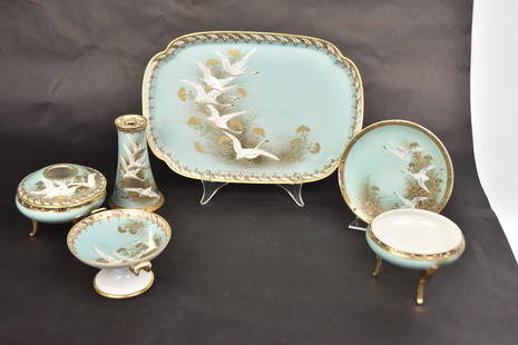 Nippon Hand Painted Jewel Enamel Dresser Set: With flying swans & gold floral on aqua. Includes 11"L x 8" W tray, 4 /4" hat pin holder, 3 1/2" covered hair reciver, 2 3/4" open box, 2 1/2"handled comport and a 5 1/2" saucer, Inside flat chip to