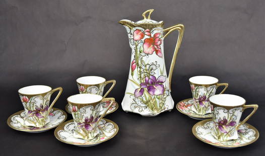 Chikusa Nippon Chocolate Set: All hand decorated with beautiful irises with gold and enamel scrolling. Includes a 9 1/82" covered pot, five 3" demitasse cups and five" Dia saucers, all marked, Lovely set in very good condition.