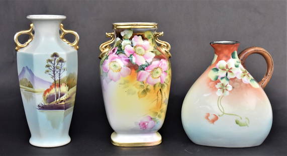 Nippon Vases Plus: Consisting a 6 1/2" Imperial ewer with floral, a 8 1/4" hexagonal vase with lake landscape and a 8" M in Wreath vase with wild roses dÃ©cor & dragon handles. Good condition.