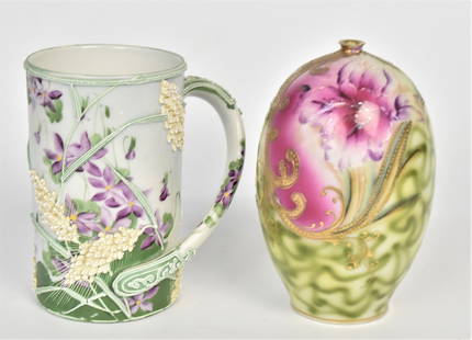 Nippon Stein Plus Vase: A 5 1/2" Moriage stein with raised wheat & painted violets, unmarked, handsome with only minor design skips, a 6' egg form vase with iris blossom & raised gold design. Both in good condition.