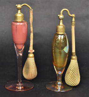 Two Atomizer Perfumes: 7" H with original bulbs the amber atomizer is marked DeVilbiss. Good condition.