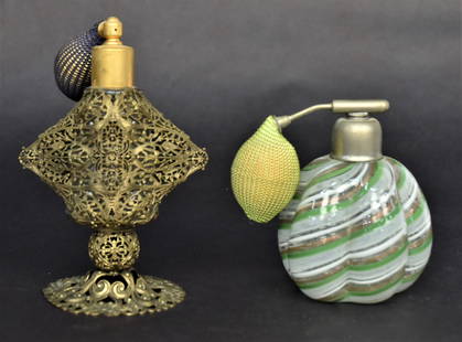 Two Atomizer Perfumes: Both with original bulbs, 4" Venetian melon ribbed plus a 5 1/2" cleara DQ bottle encased within a filigree frame. Good condition.