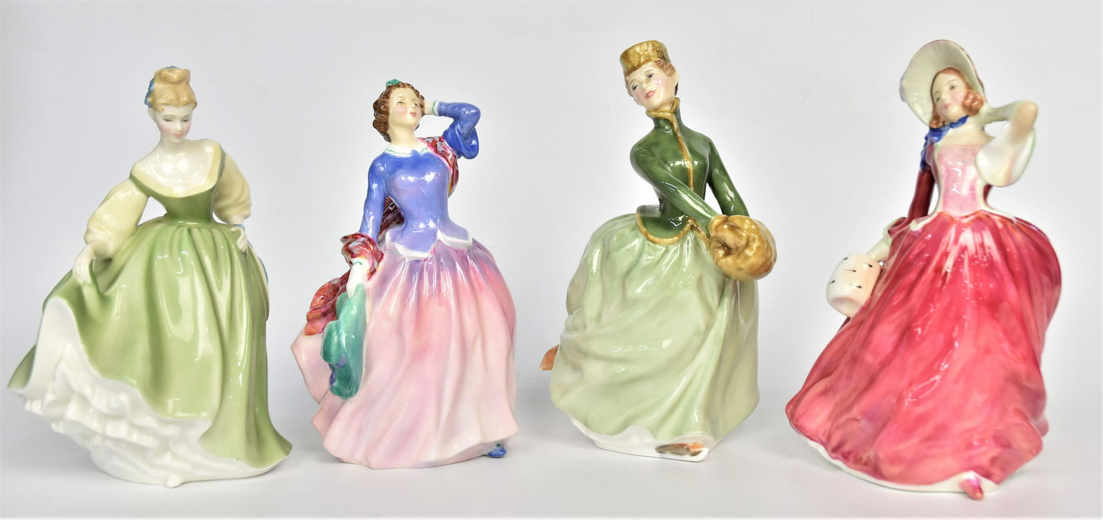 Four Royal Daulton Figurines: Autumn Breezes - 7 1/2", Blithe in Morning - 7 1/2", Fair Lady - 7 1/2", Grace - 8". All good condition.