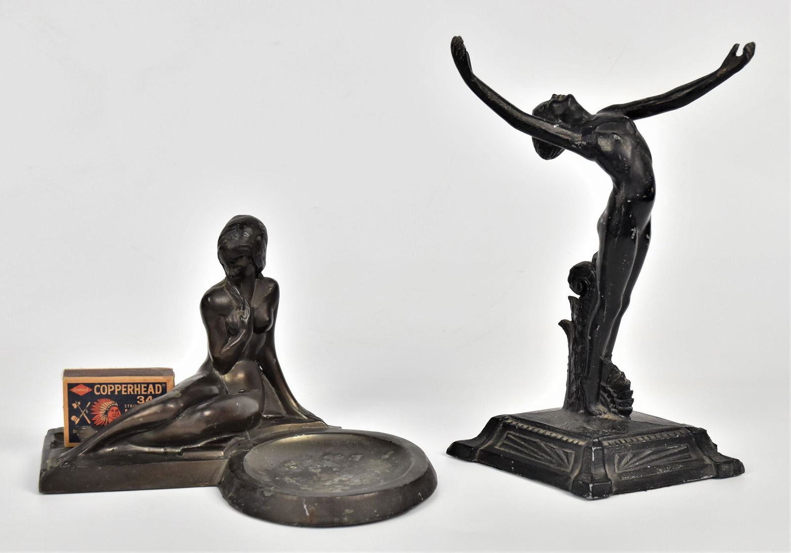 Pair Frankart Cast Metal Nude Figurines: Cressent Metal Works match holder & ash receiver 5" x 7"L, plus an Art Deco dancer 8"H x 6" base, unmarked. Conition wear to finish.