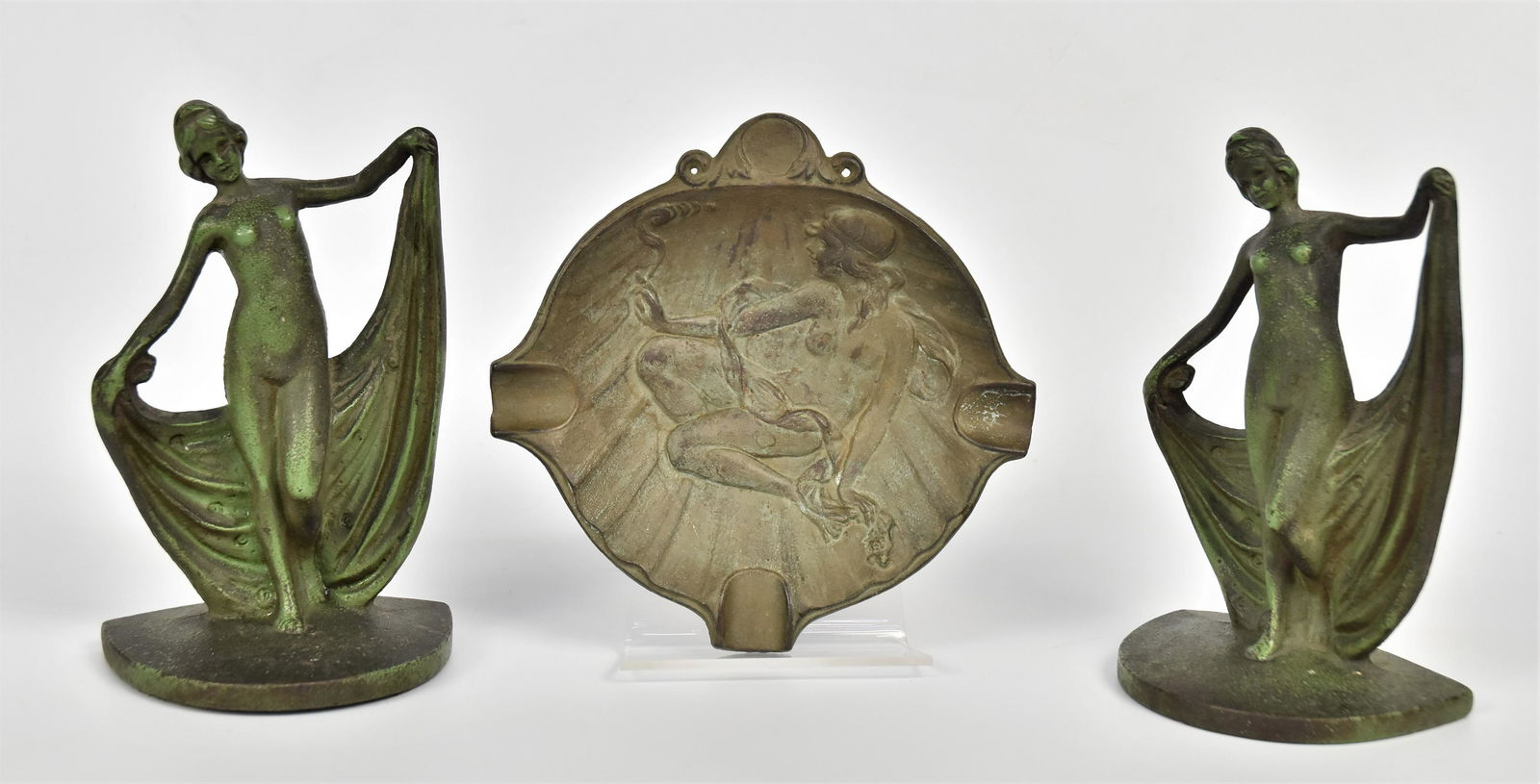 Three Cast Metal Nudes: Pair of nude scarf dancers bookends 7'H, plus a nude in tray 1" x 6 1/2". Condition wear to finish.