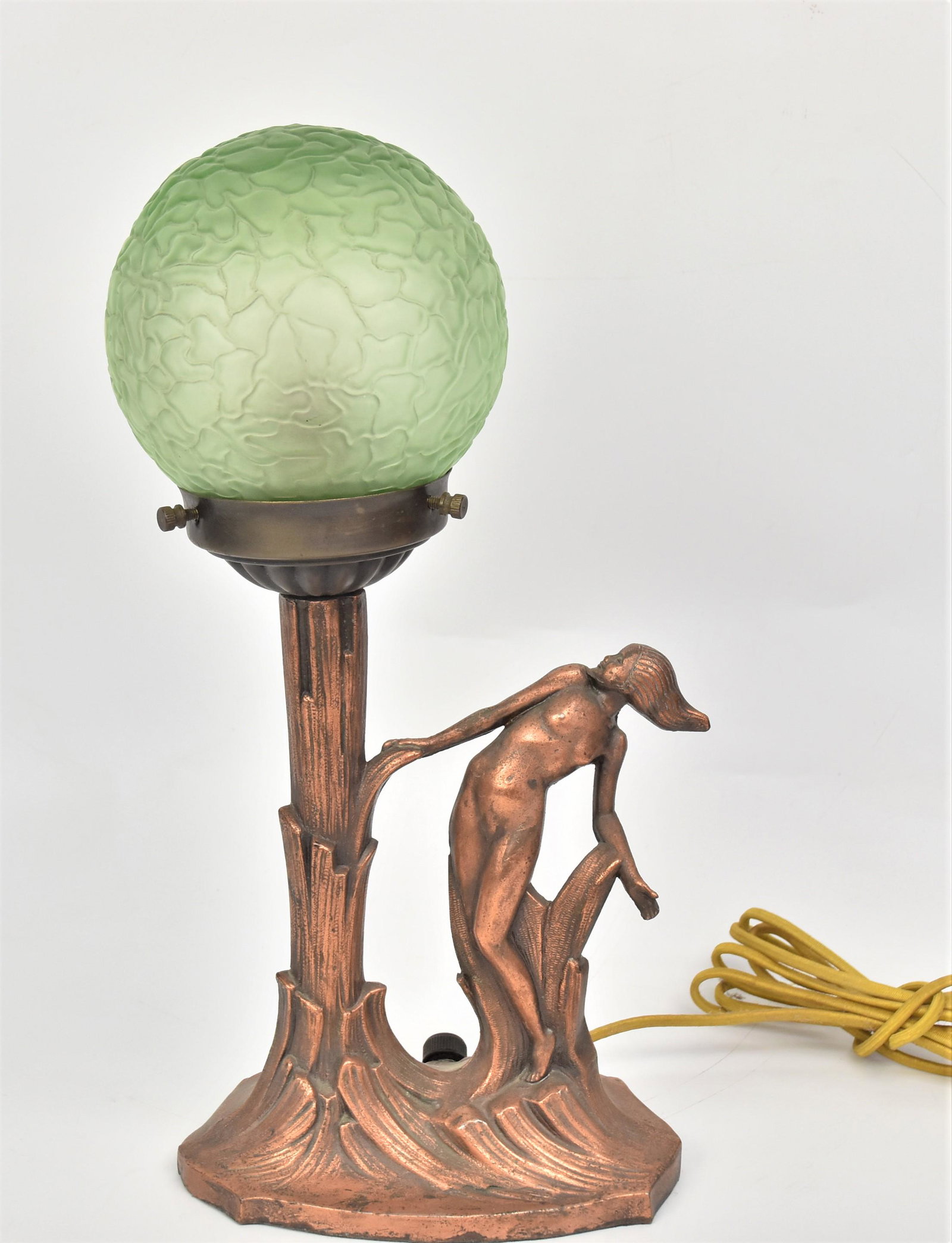 Art Deco Figural Boudoir Lamp: Green frosted crackle glass globe shade, mounted on tree trunk with nude female standing next to it, all in original copper finish, 7 x 4 1/2 x 14 1/2" high. Condition VG.