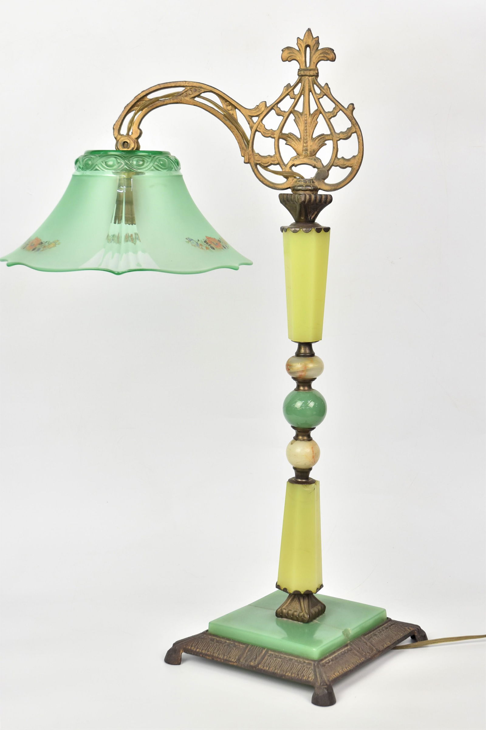 Slag Glass Bridge Lamp: Slag glass, onyx & cast iron base with molded and 11" diameter partially frosted green glass shade with polychrome floral decoration, 28" high. Condition crack in base piece of green slag glass, else