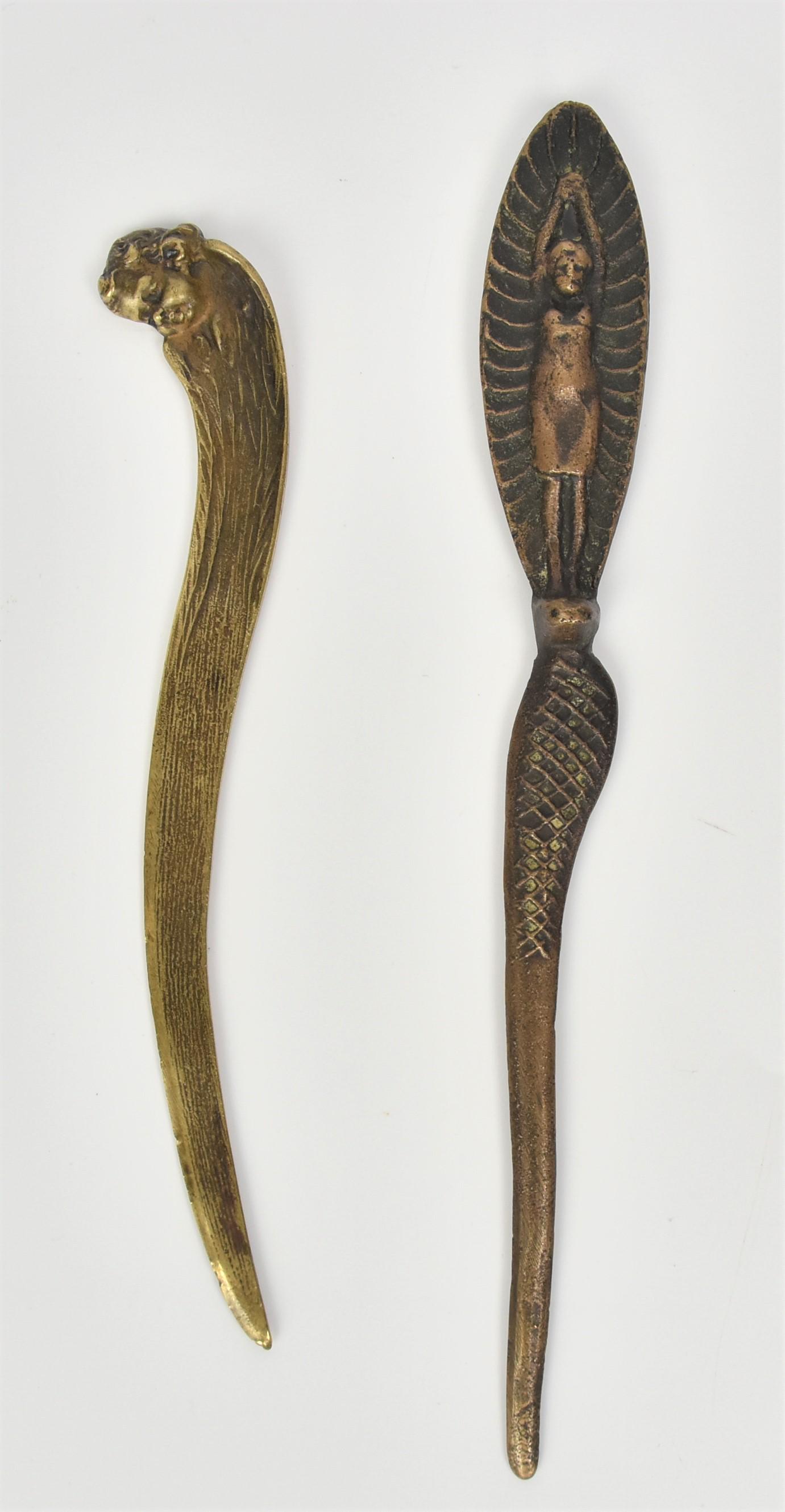 Two Figural Bronze Letter Openers: Including one Egyptian revival pieces with cobra and woman handle, 10 1/4" long; and one with childs head, 8 1/2" long, both with nice patina. Condition Fine.