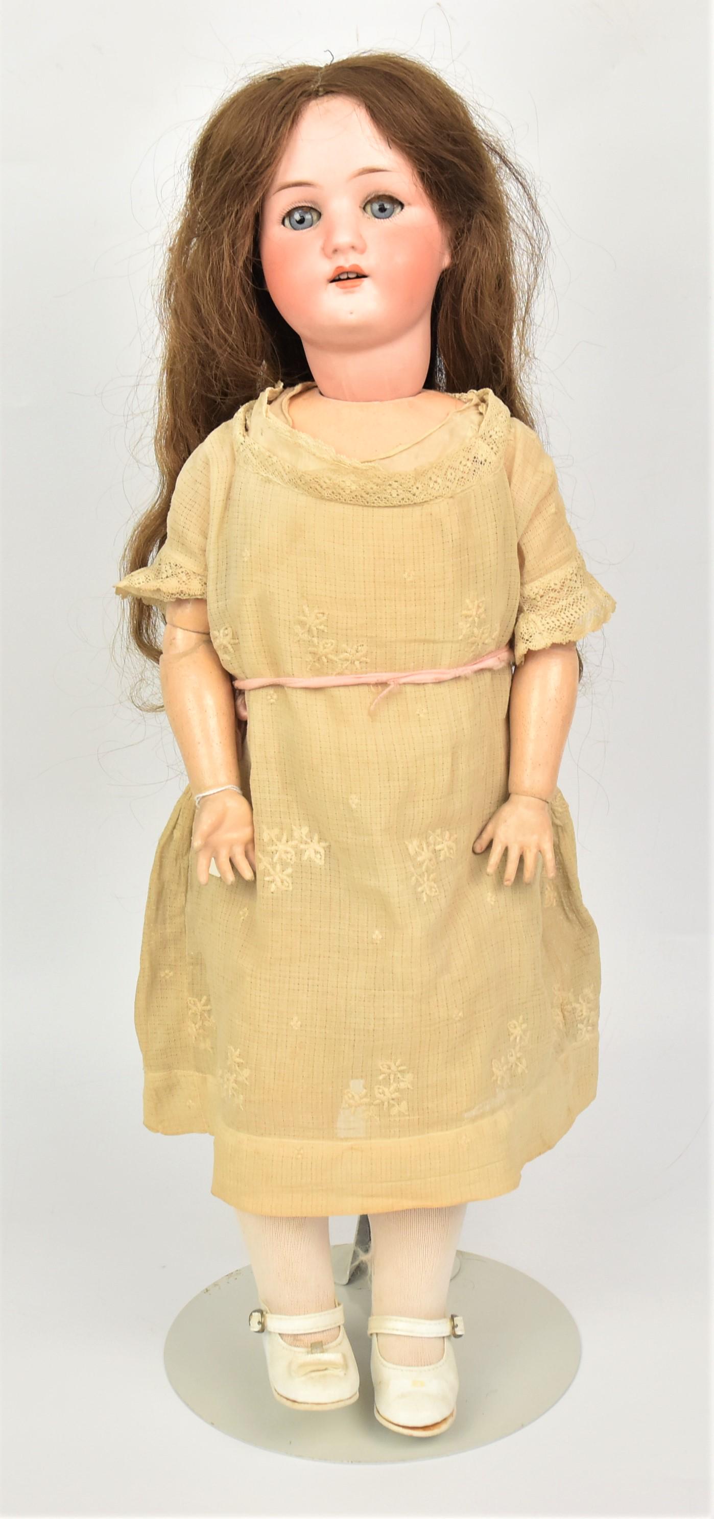 Haubach Korppelssdorf Bisque Head Doll: Measures 23" H socket head doll on composition jointed body, blue sleep eyes with fur eyelashes, marked and numbered on back 50-4, original dress. Good condition.