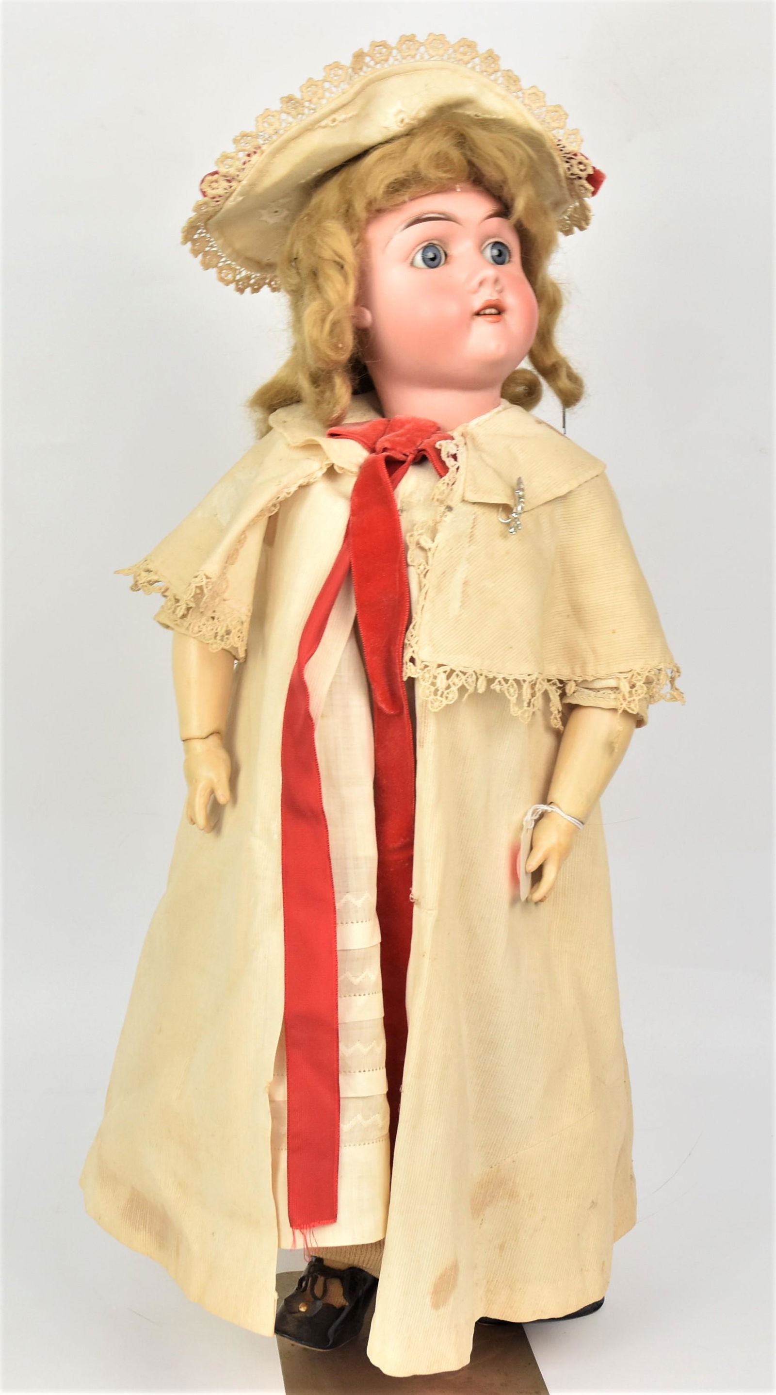 Max Handwerck Bisque Socket Head Doll: Marked on back as above and 285/29 Germany 3X, blue glass eys, open mouth with original blonde wig on jointed composition body with period outfit and newer shoes, 23" tall. Condition one finger repair