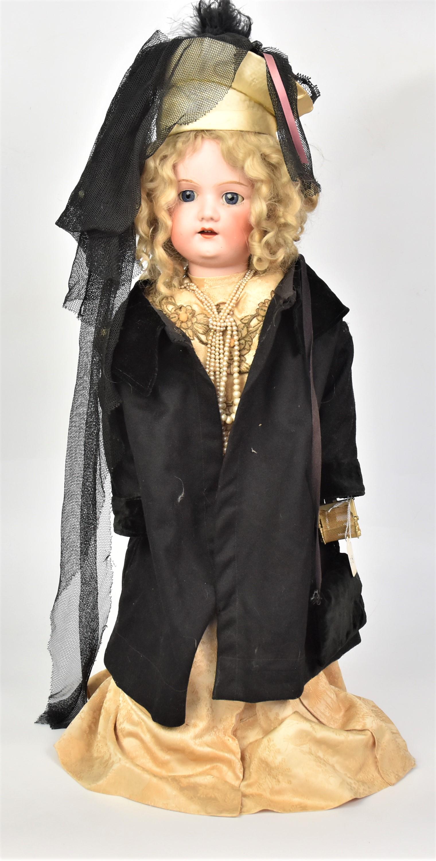 MB Japan Bisque Socket Head Doll: Marked MB in circle with double ended tridant & Japan, with blue glass sleep eyes, open mouth original blonde wig, period outfit with hat and black cape and metal purse, original shoes, jointed compos