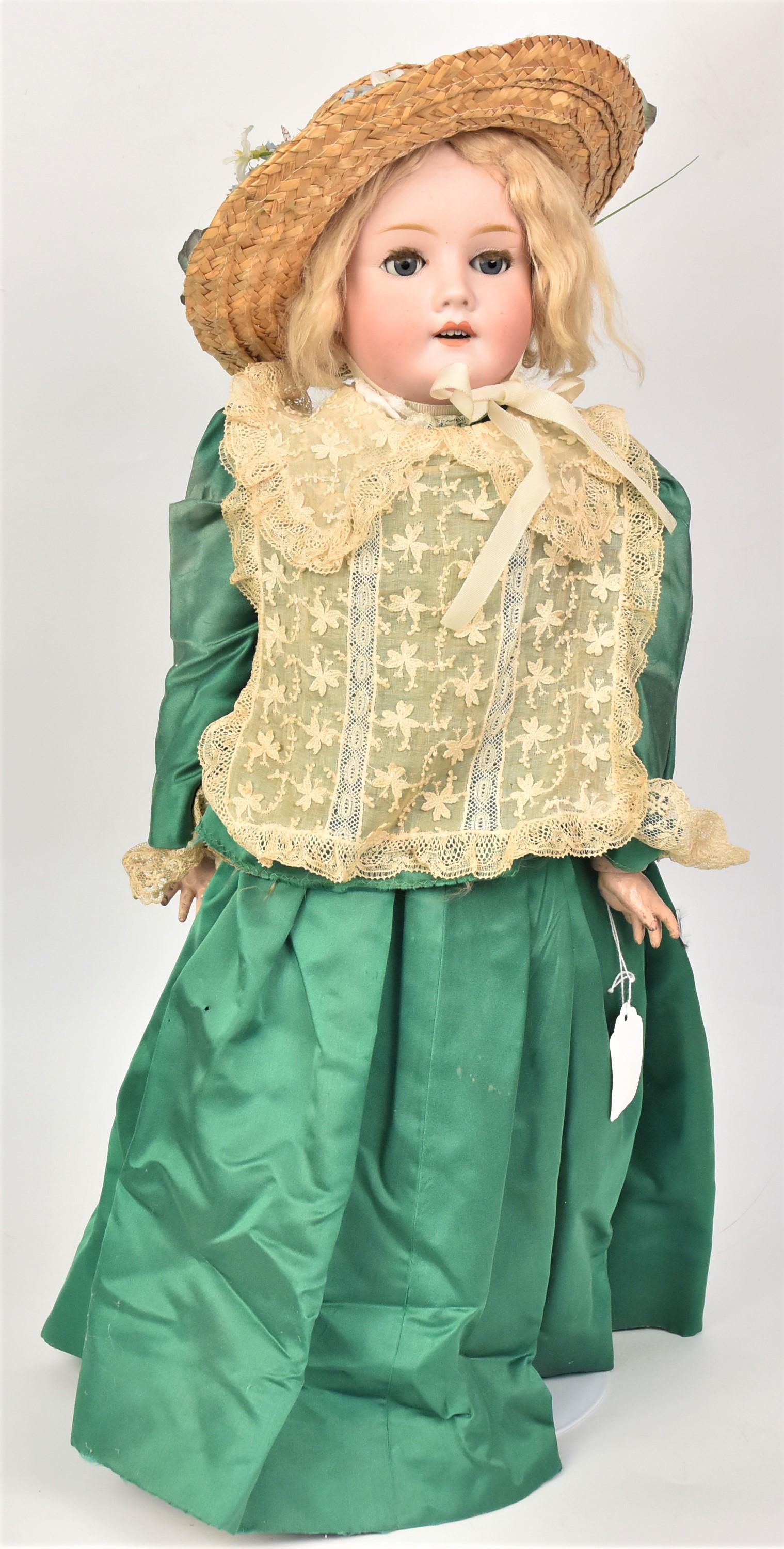 German Bisque Socket Head Doll: Marked on back of neck Special/65, with gray glass sleep eyes, original blonde wig on jointed composition body with older green outfit & straw hat, 25" tall.