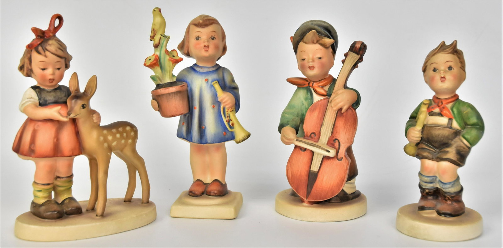 Four Hummel Figurines Full Bee: Including # 186, #97, #136/1, " Congratulations " (unmarked) tallest 5 3/4" H . All in good condition.