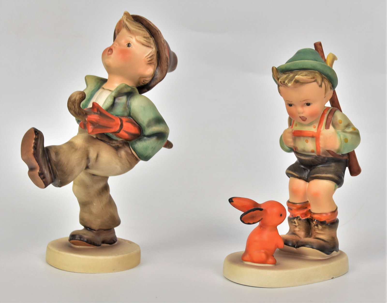 Two Large 8" Hummel Figurines: Including #109/2, # 6/II , Umbrella Boy 8" TMK-3 mark . 7 1/2" TMK-3 mark, very tiny flea bite on base. Otherwise very good condition on both