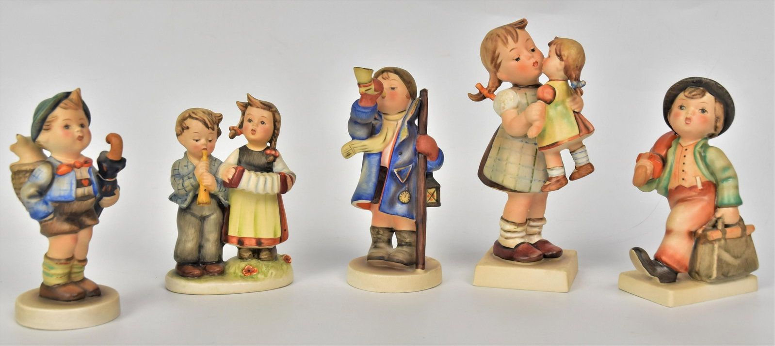 Five Hummel Figurines: Includes #311 Kiss Me TMK-3, #198 2/0 - TMK-2, #218 2/0 TMK-2, Umbrella Boy TMK-3, #15/0 TMK-3, Tallest 6 1/2". Good condition.