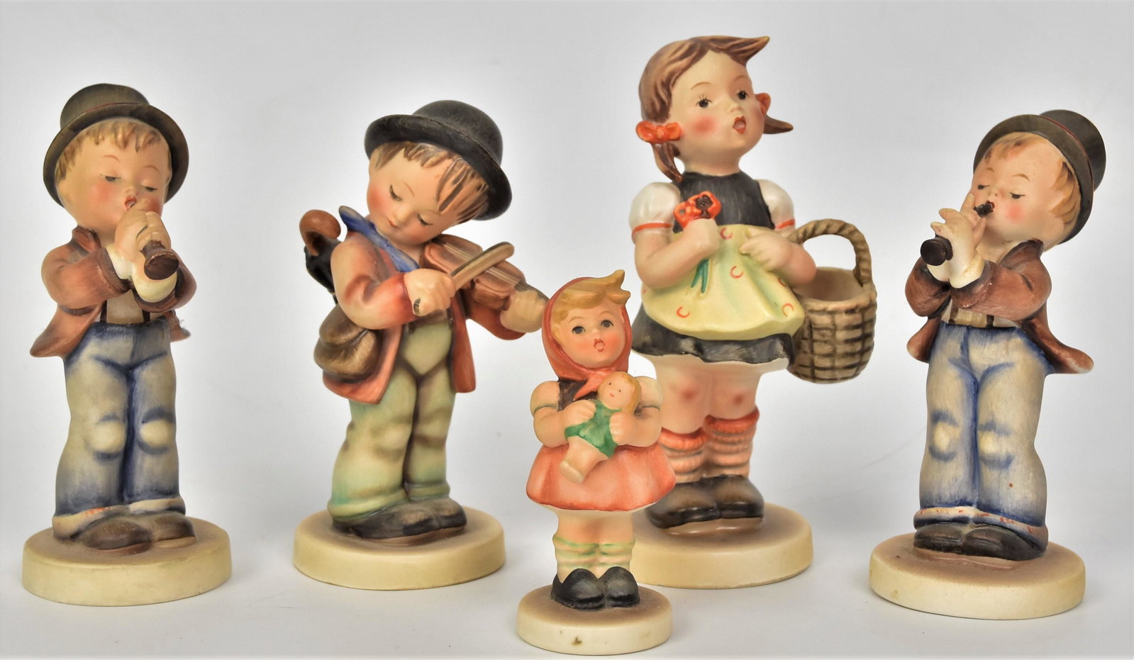 Five Hummel Figurines: Tallest is 5 3/4" includes #98 TMK-2, #4 - TMK-2, #85 /0 unmarked,# 85 /0 TMK-2, #239/3 dated 1967 unmarked. Good condition.