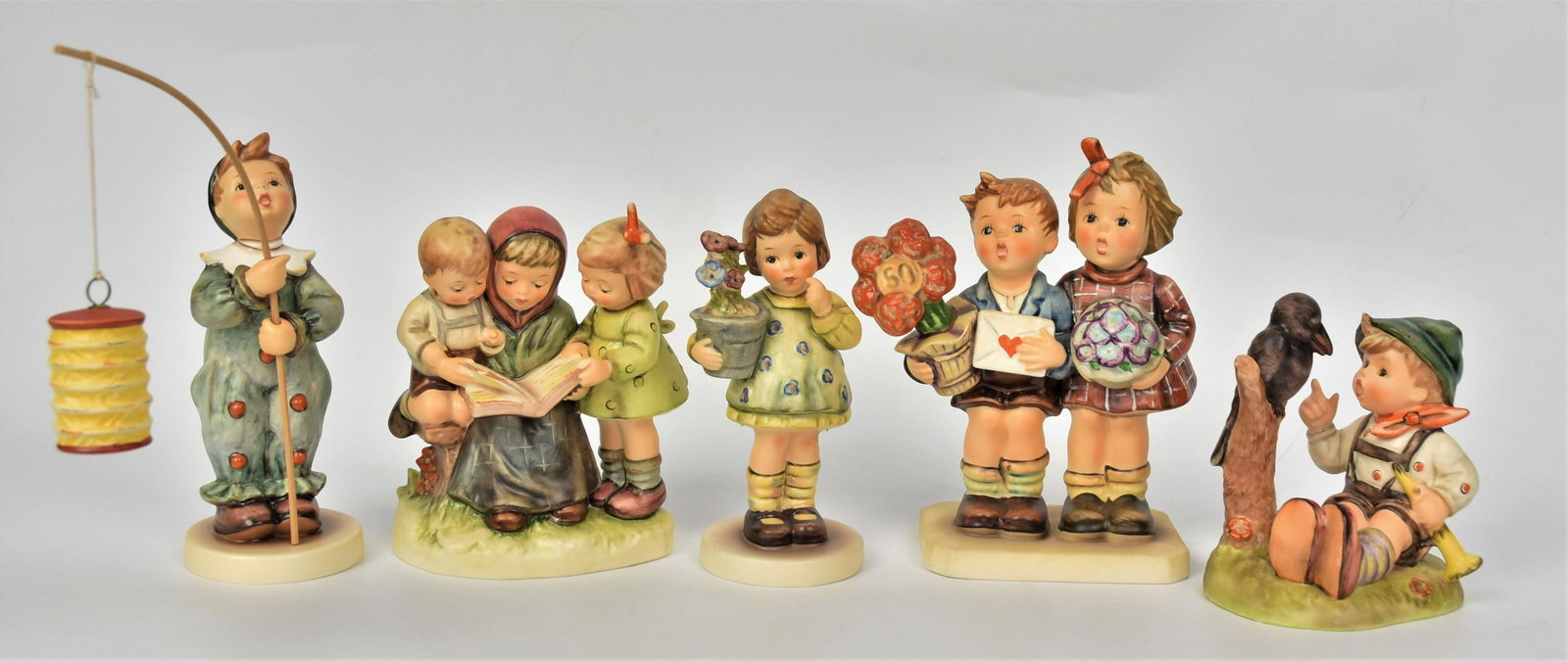 Five Hummel Figurines: Includes #6/6 TMK-7 #463/0 TMK-7 , #433 TMK-6 artist signed & dated, #416 TMK-6, #458 TMK-7 , tallest 8 3/4 to top of flag. All good condition.
