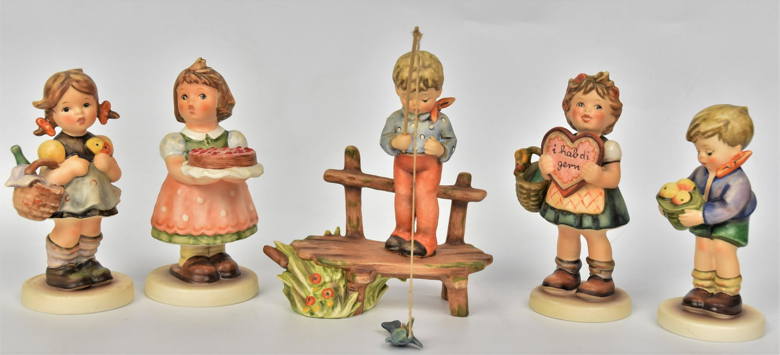 Five Hummel Figurines: includes #337 TMK-5, #440 TMK-6, #566 TMK-7, #363/0 TMK-7, #485 TMK-7. Tallest is 6" without stand. All good condition.