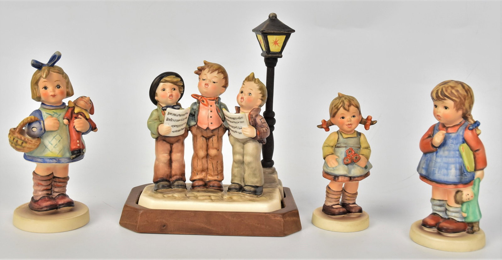 Four Hummel Figurines: Includes #548 TMK-6, #757 TMK-7, #422 TMK-6, #486 TMK-7, tallest is 7 1/2". All good condition.