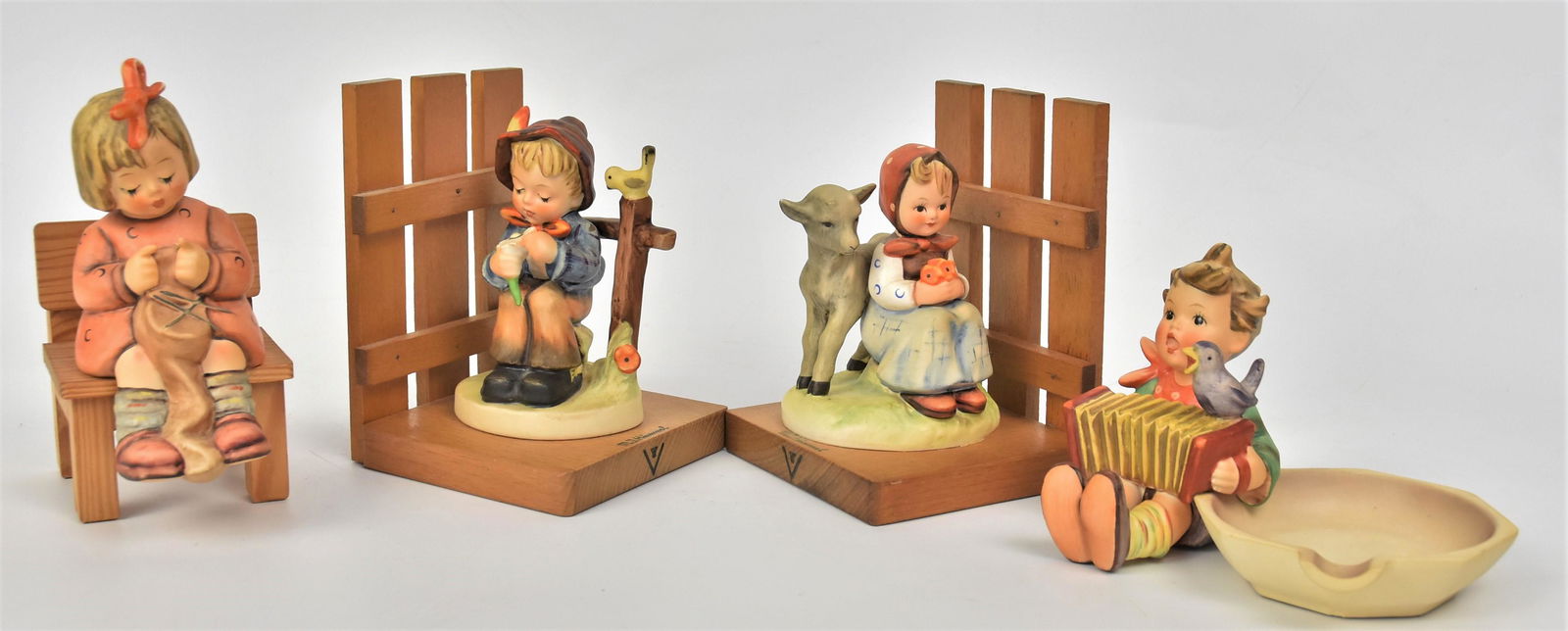Four Hummel Figurines: Includes #759 TMK-7 hairbow has small repair, #114 TMK-5, Pair of Bookends #182 Good Friends and She Love Me She Loves Me Not both TMK-3. Tallest is 5". Good condition.