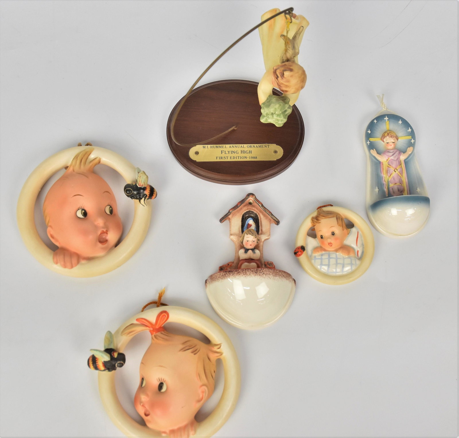 Hummel Wall Plaques Plus: Includes Wall hangings #30/0 B & 30 /0 A, #137 TMK-6, #164 TMK-2, ROB 402 TMK-5 impressed ROBSON at top, and Flying High Ornament on stand marked first edition 1988 TMK-6, largest is 5" . All good con