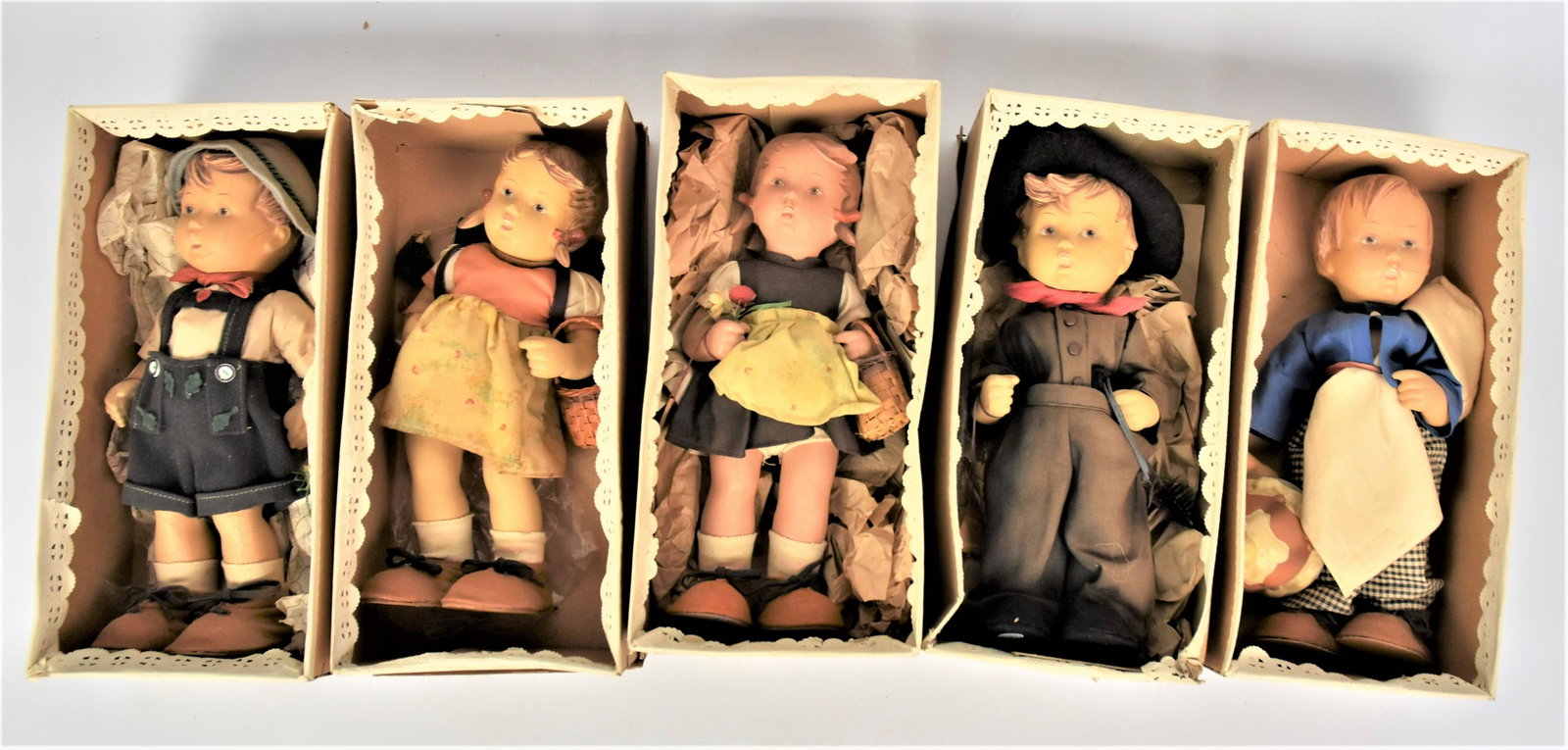 Five rubber 11' Hummel Dolls: Lot of 5 Hummel dolls, 1 missing arm, some craquelure to each.