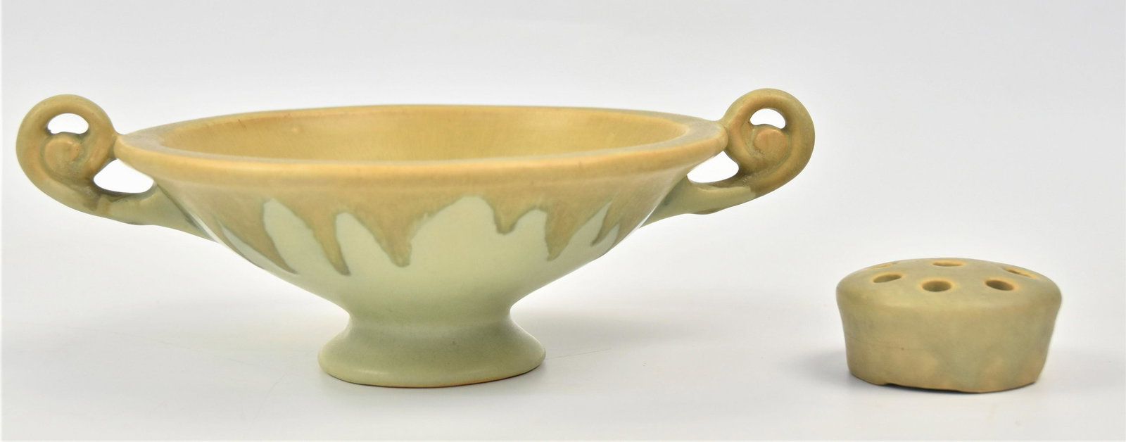 Roseville Carnelian I Pottery: Drip brown/green pedestalled compote and flower frog marked with same blue R, 10 x 7 1/4x 3 1/4" high with frog 2 1/2" diameter x 1 1/4" high. Condition Both Fine.