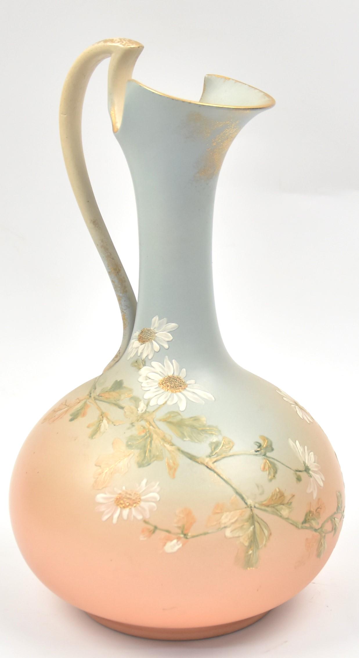 Rookwood Limoges Ewer: By Anne Valentine. Date 1889. Shape 462. Graceful arrangement of daisies highlighted by gold. Measures 10 3/4"H to handle top. Incised artist monogram. Impressed W for white clay body. Well excuted de