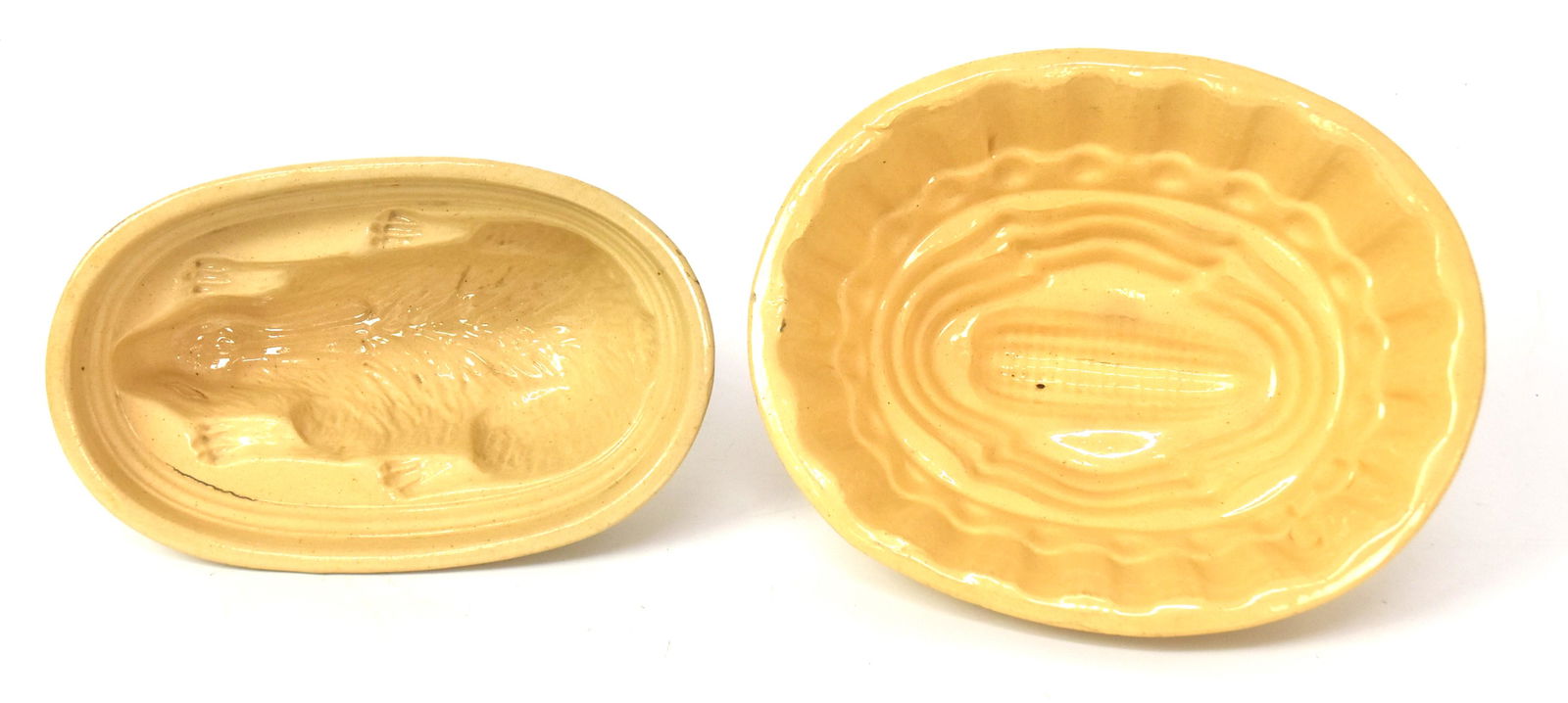 Two Early Yelloware Molds: Including unusual rabbit, and corn. Largest 4" 9 1/4"W x 7 1/2"D.