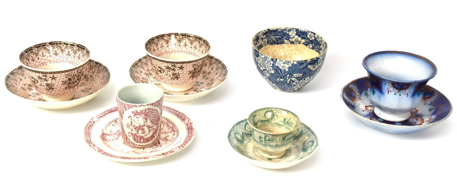 Staffordshire Cups & Saucers: Including one Gaudy Ironstone example; and pait of pearlware in London shape transfer print; plus one miniature octagonal London shape transfer print in green, all handlless; plus odd saucer in red tr