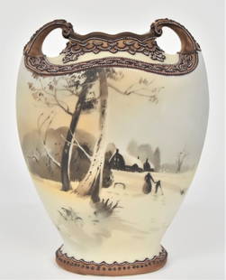 Handled Scenic Nippon Vase With Mother & Child: Walking through a snow covered landscape with distant homes. Decorative enameling on the shoulder & base. 7 3/4” T. 6” W. Very good condition. Green mark.