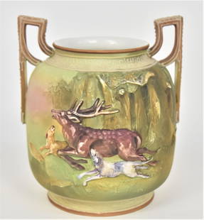 Nippon Relief Mold Stag & Hounds Handled Vase: Decorative Moriage trim. 6 1/2”T. 5 1/4”W. Green mark. Impressive vessel. Very good condition.