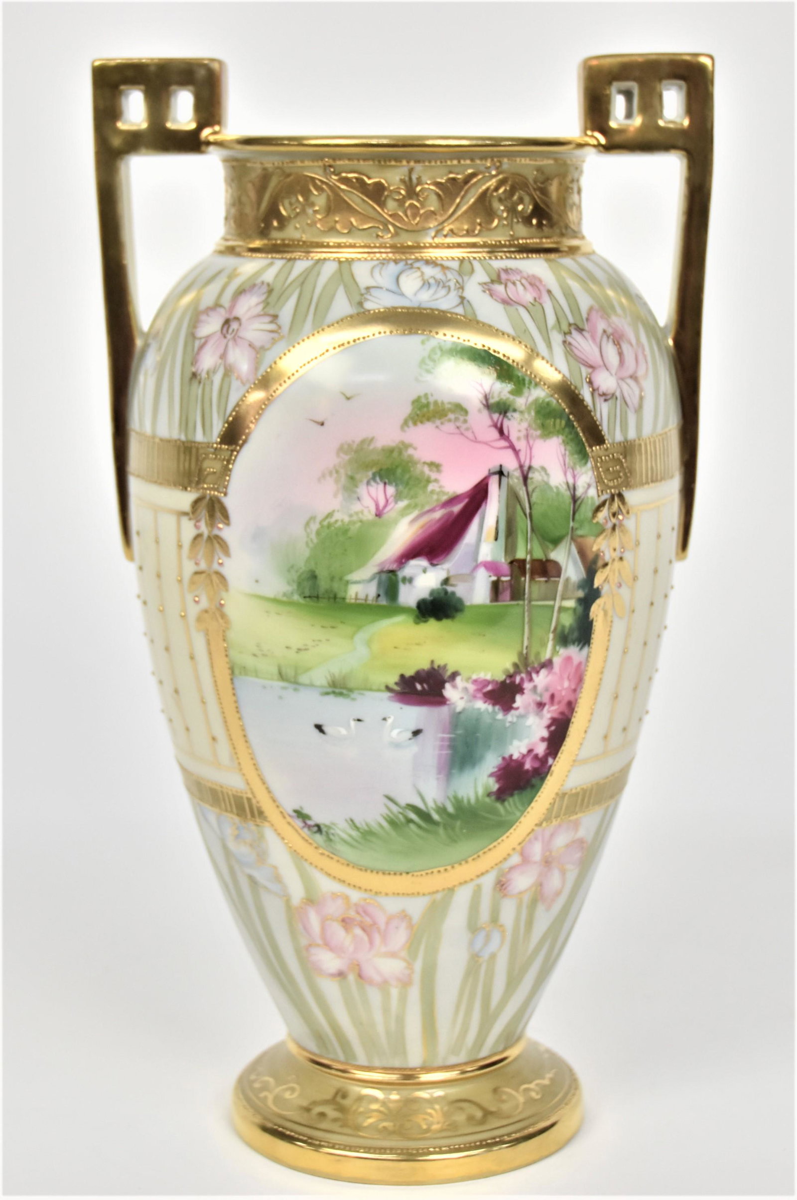 Lakeside Cottage & Scenic Nippon Urn With Pierced Handles: Raised gold designs. Abundance of gold application. Pastel florals. 11 7/8”T. 6”W. Colorful & pleasing. Very good condition. Green mark.