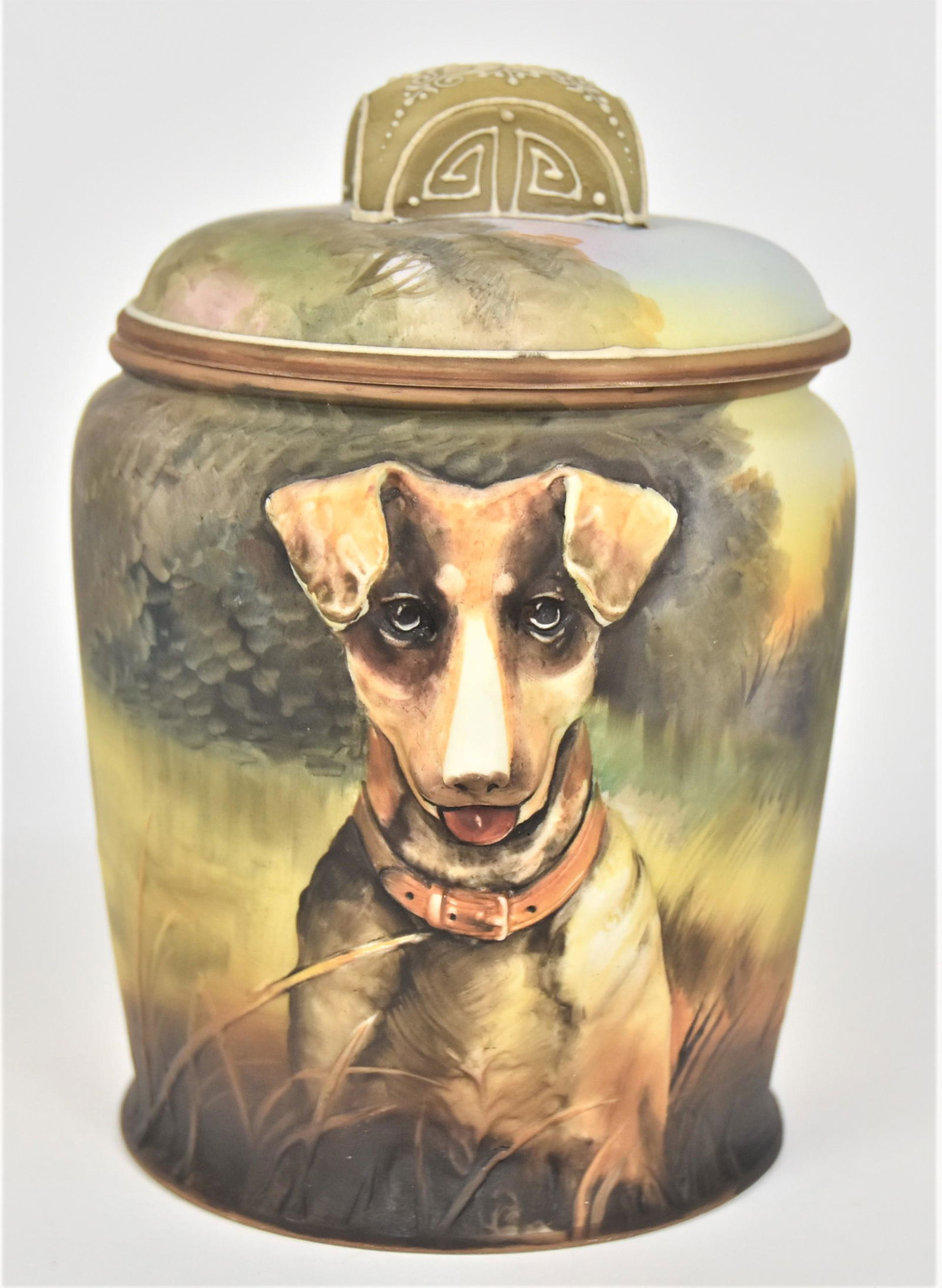 Nippon Relief Mold Covered Humidor: With the portrait of an alert dog. Moriage trim to covers finial. 7”T. 5”D. Small nick to backside of covers rim. Pleasurable subject matter. Green mark.