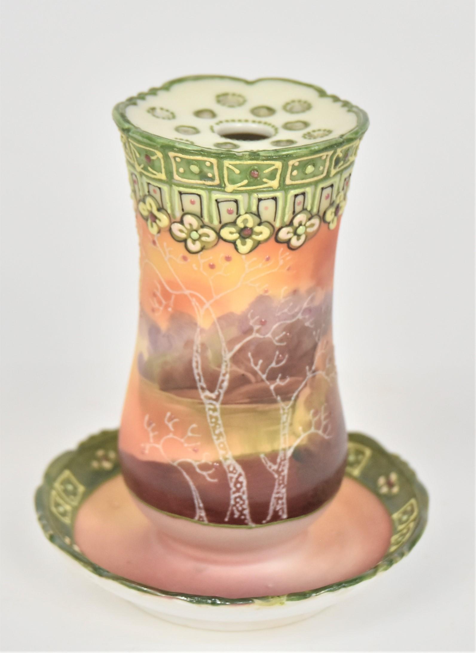 Nippon Hatpin Holder With Galle Scene: Enameled trees. 4 1/2”T. 3 3/4”D tray. Pleasing design. Very good condition. Blue mark.