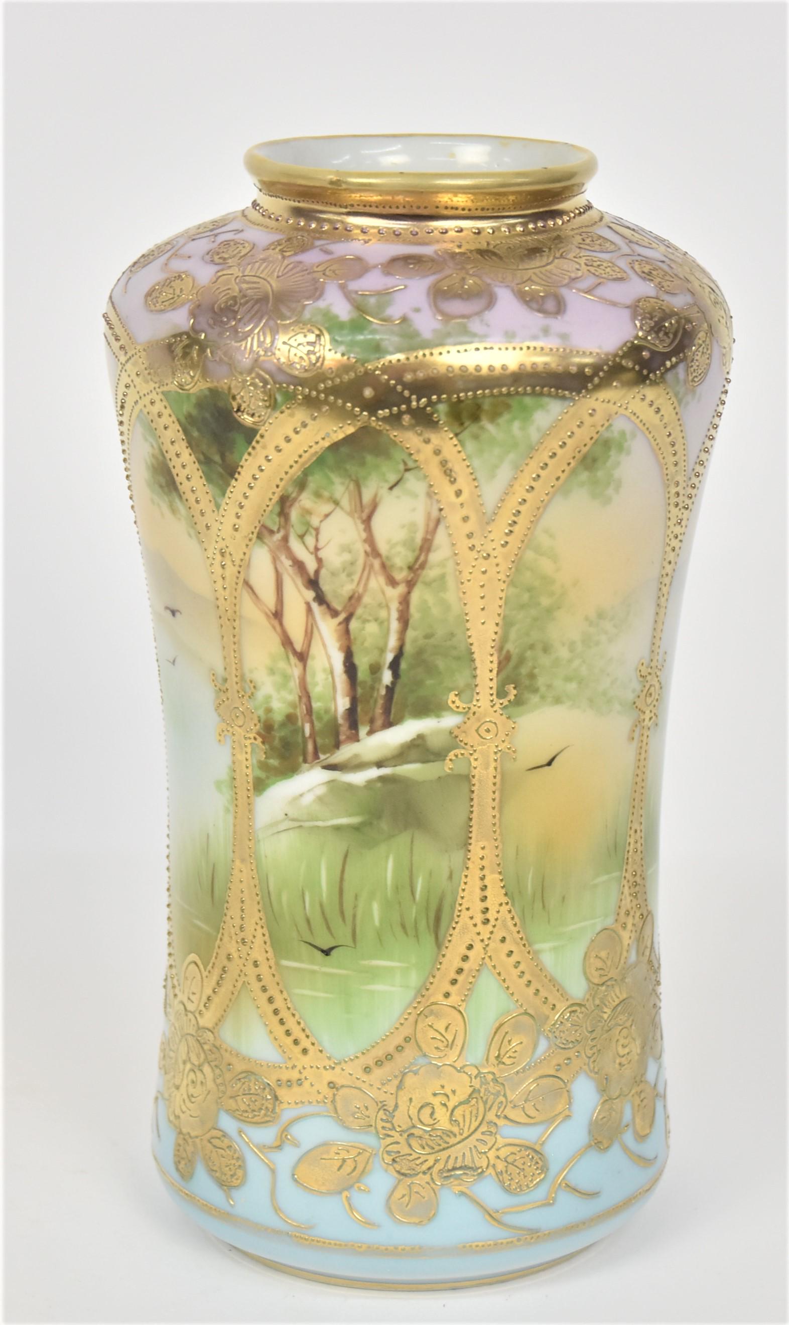 Nippon Gold Caged Vase: Revealing a tranquil lake setting With birds on the wing & an island With trees. Raised gold floral. 8 3/8”T. 4 1/2”D shoulder. Very good condition. Green mark.