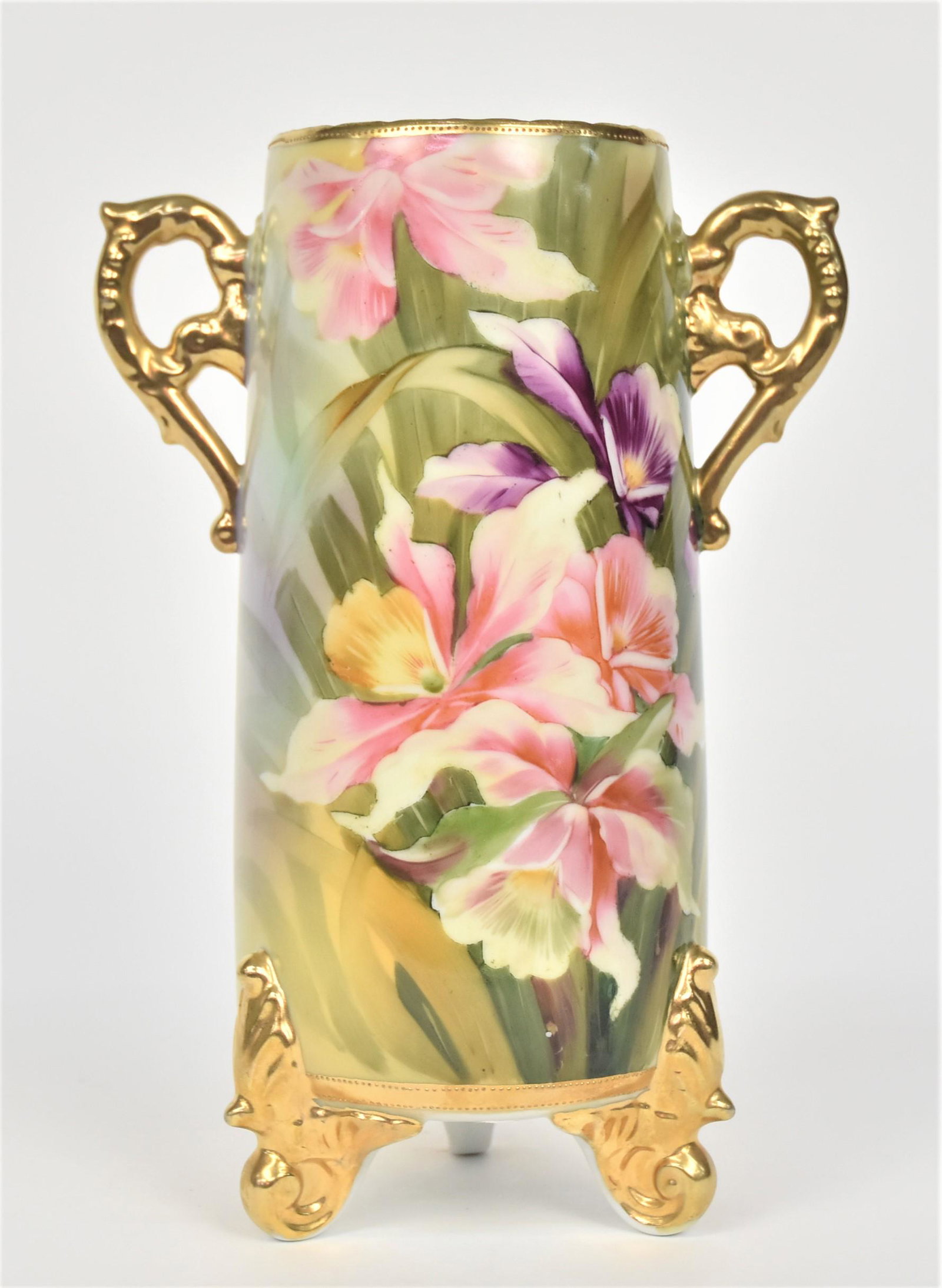 Colorful Orchids Decorated Nippon Vase: With fancy gold handles and three acanthus leaf feet. 10”T. Green mark. Very good condition.