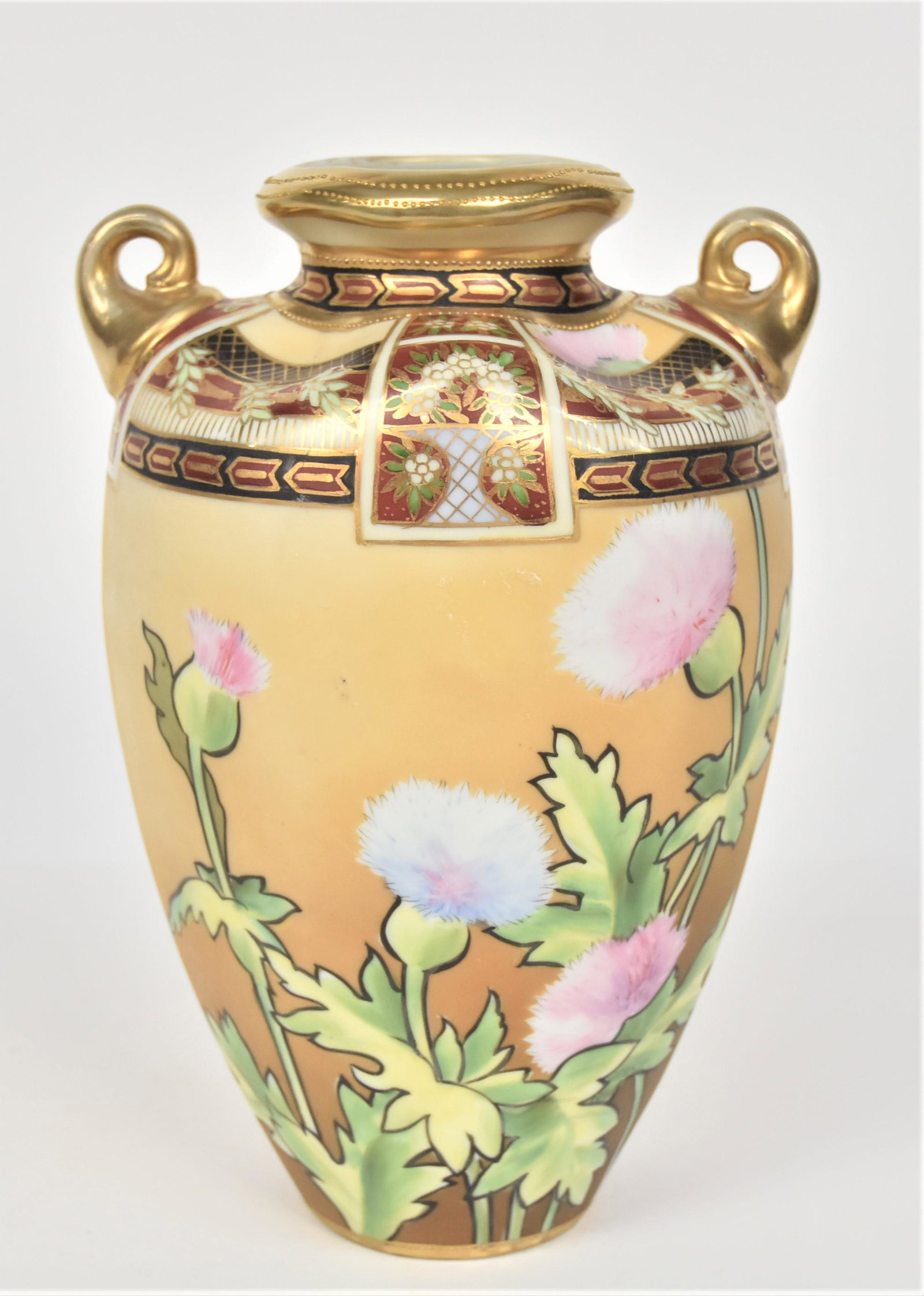 Nippon Concave Shouldered Vase: With a stand of flowering teasels. Ornately decorated shoulder. Gold scroll handles. 10”T. 6 3/4”W With handles. Wear to gold. Good condition. Green mark.