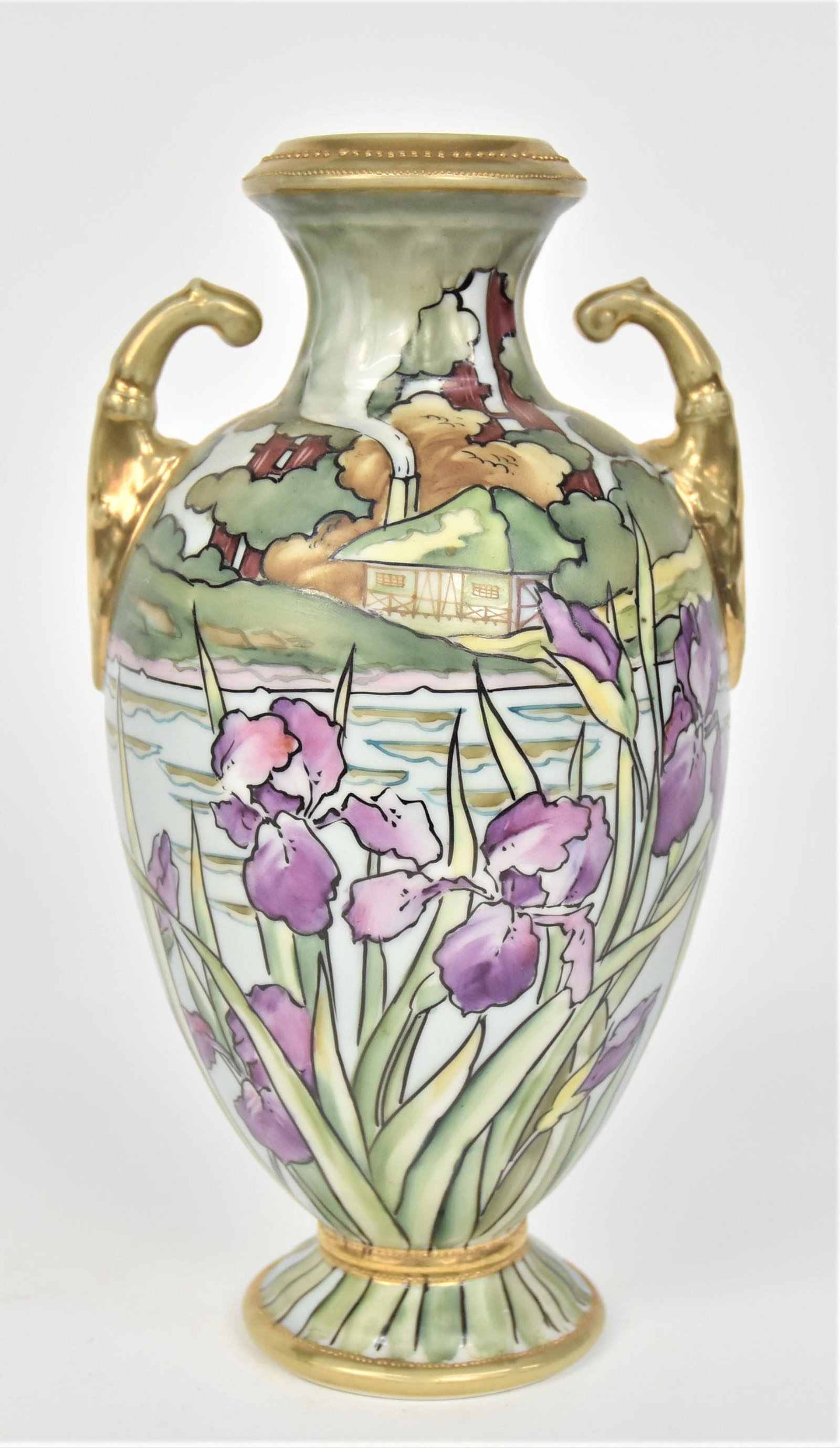 Nippon Summer Landscape Vase: With a stand of irises overlooking a coastal home With a smoking chimney. Gold acanthus leaf open handles. 10” T. 5 1/4”W. Very good condition. Blue mark.