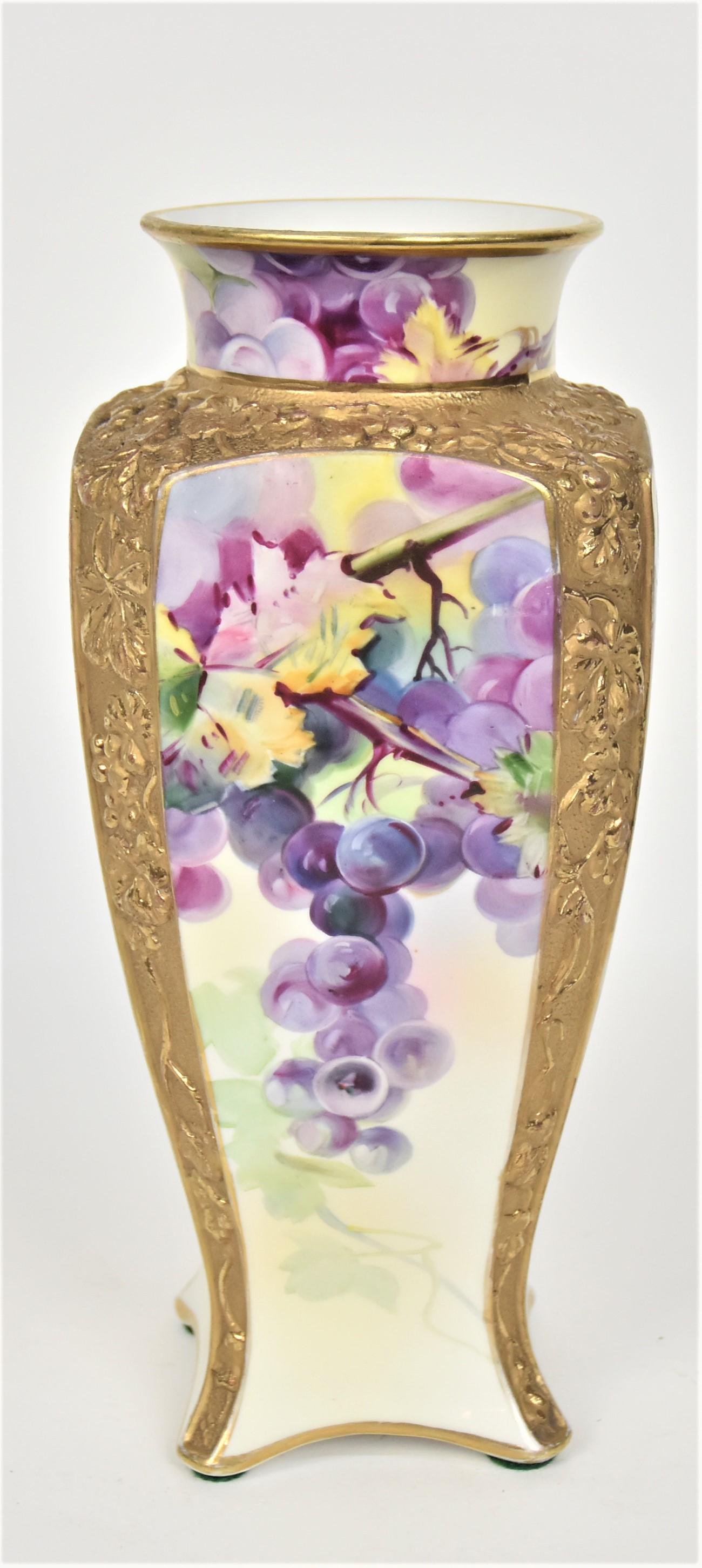 Nippon High Relief Molded Gold Floral Vase: Bordering four panels decorated With grapes & leaves on the vine. 10 1/2â€™T. 4 1/2”W. Impressive Vase. Very good condition. Green mark.