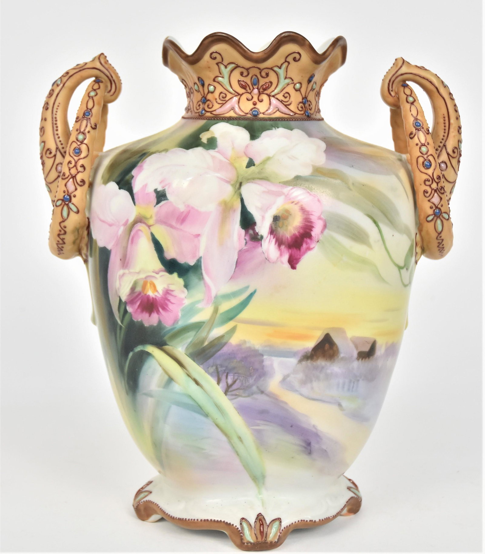 Impressive Nippon Jeweled Vase: With orchids overlooking a frosty appearing landscape With a cottage. Elaborately decorated ring & horn handles and scalloped collar. Jewels enhance the relief base. 9 3/8”T. 8” across the