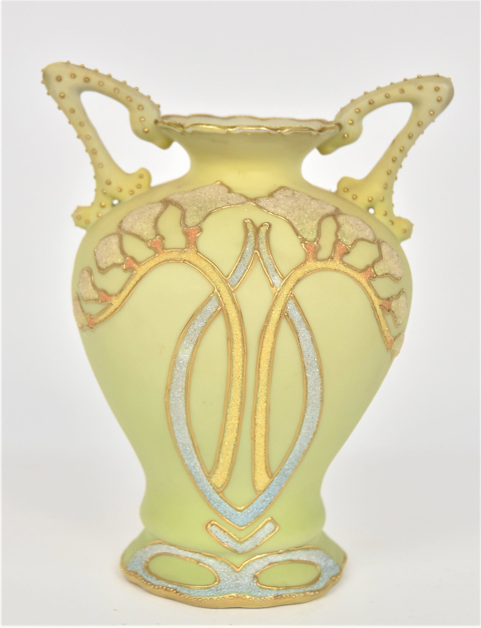 Nippon Coralene High Handled Vase: With Freesia blossoms & sinuous stems. Beaded handles. 6 1/2”T. 5” across the handles. Very good condition. Unmarked.