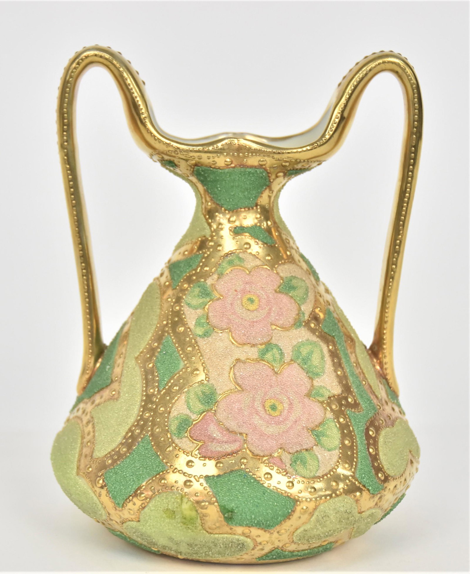 Nippon Coralene & Gold High Handled Petticoat Vase: With roses & beaded gold trailing through patches of Coraline. 6 1/2”T. 5” across base. Small Coraline skip at widest area. Appears factory related. Good condition. Purple mark.