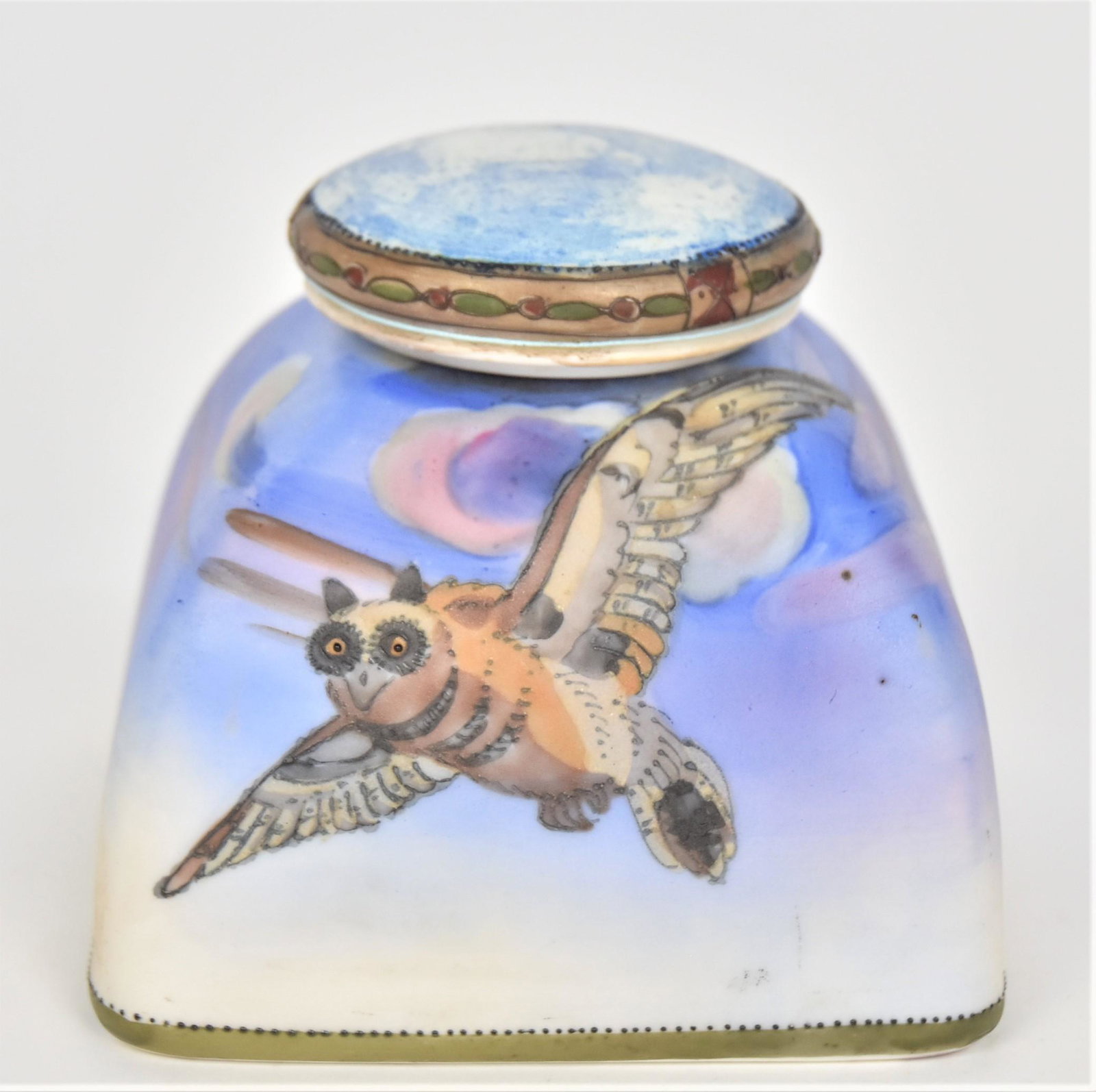 Nippon Covered Ink Well: With owl in flight at nightime. Porcelain insert. Cover has raised enameling. 3 1/4”T. 4”D. Good condition. Green mark.
