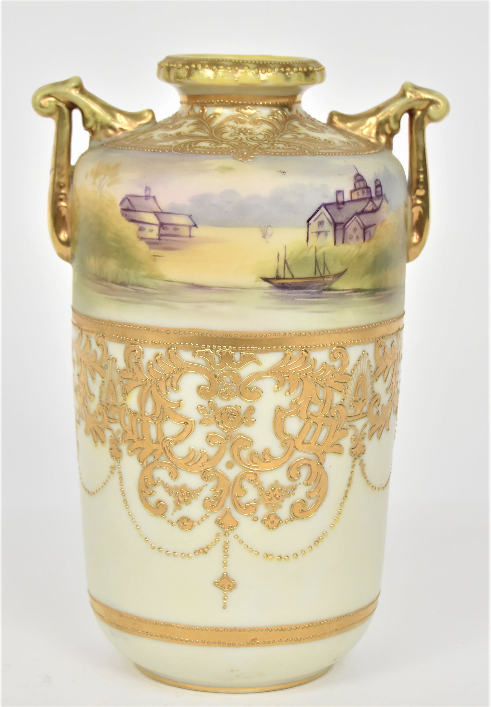 Nippon Landscape Vase: Embellished With raised gold bordering. Acanthus leaf handles. 8”T. 5” across handles. Good condition. Blue mark.