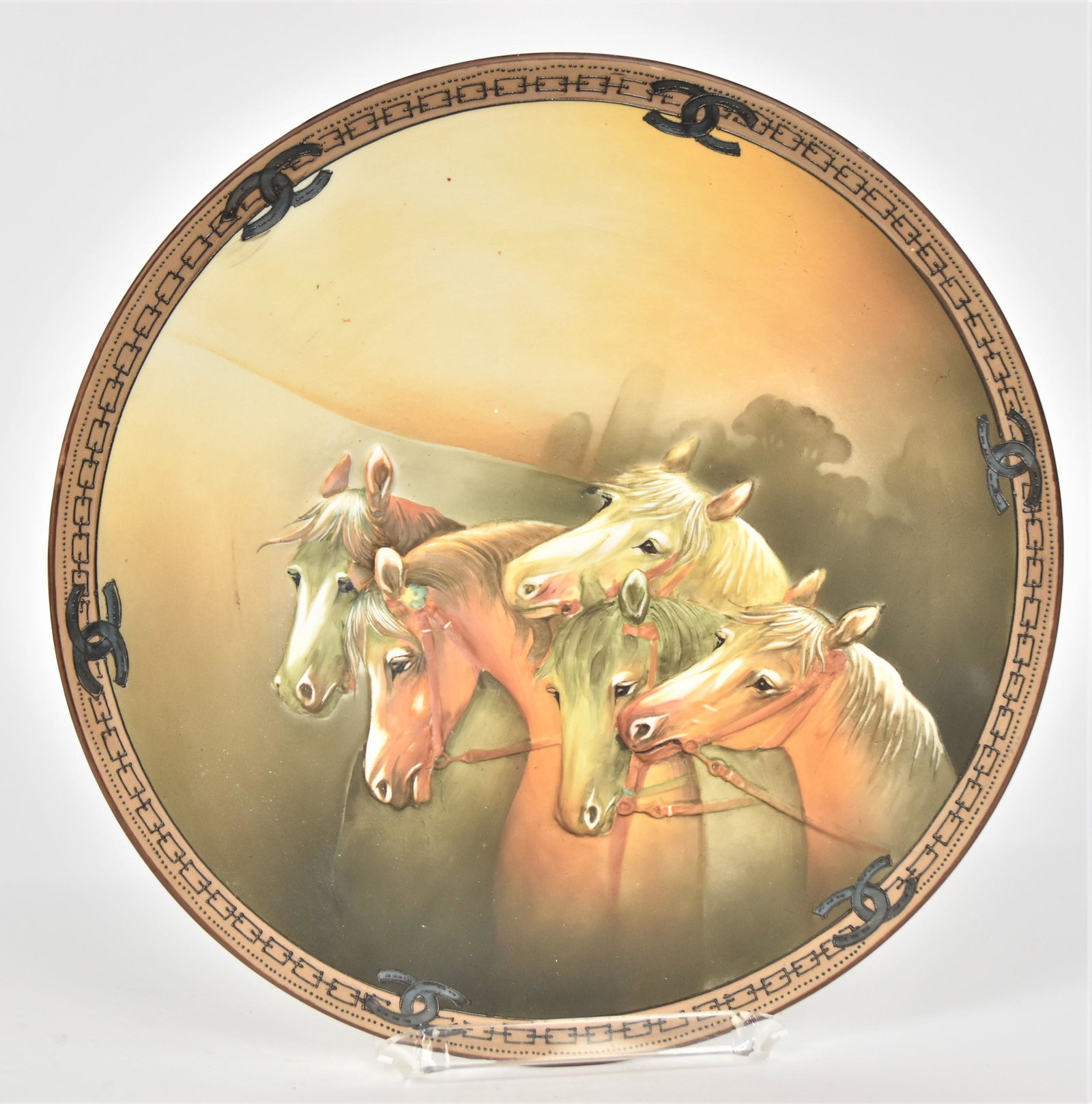 Nippon Molded in Relief Plaque: With five stallions. Decorative horseshoe & chain link border. 10 1/2”D. Handsome five some. Very good condition. Blue mark.