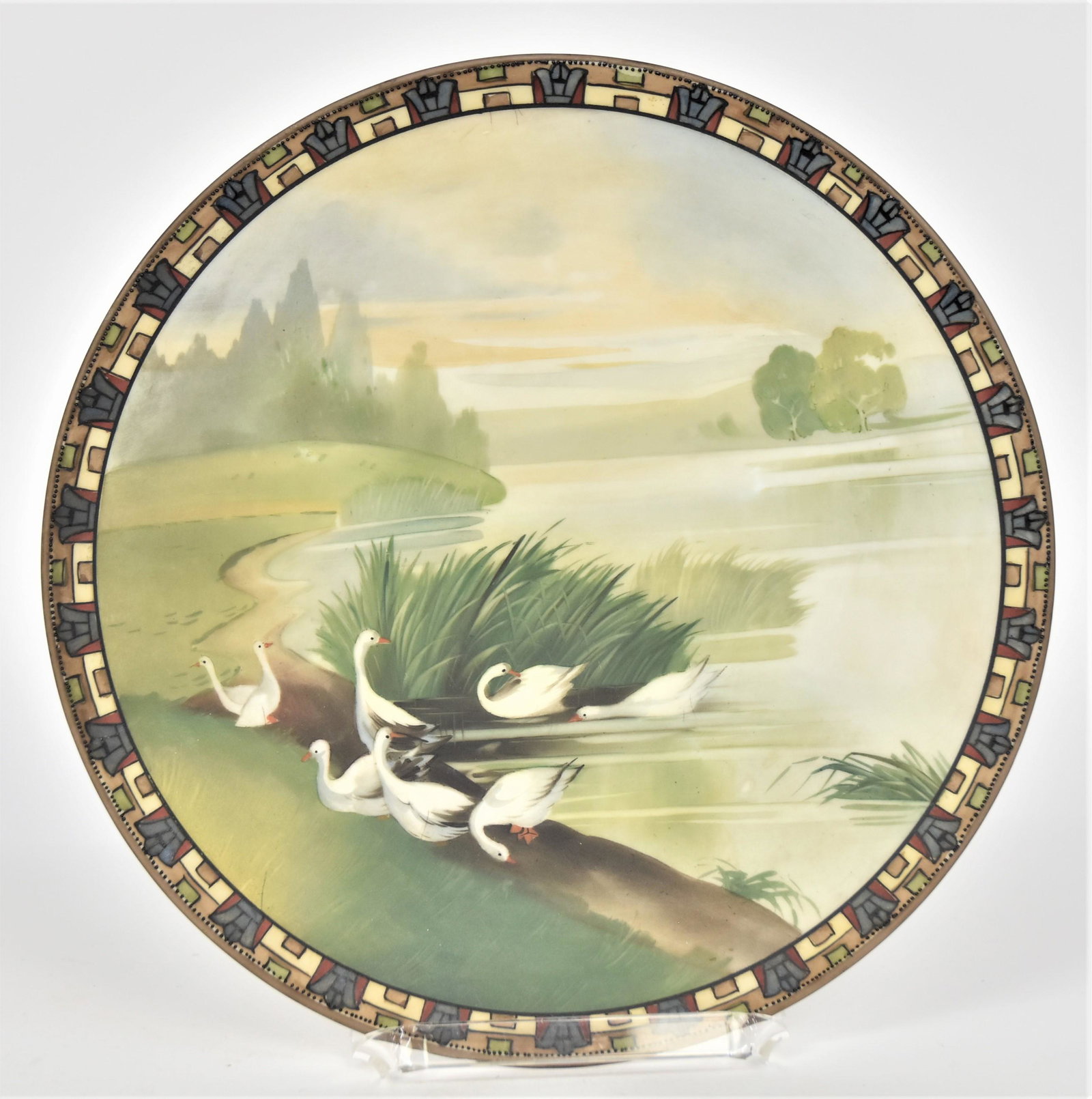 Nippon Serene Lake Scenic Plaque: With eight swans a preening. Attractive decorated border. 10”D. Very good condition. Green mark.