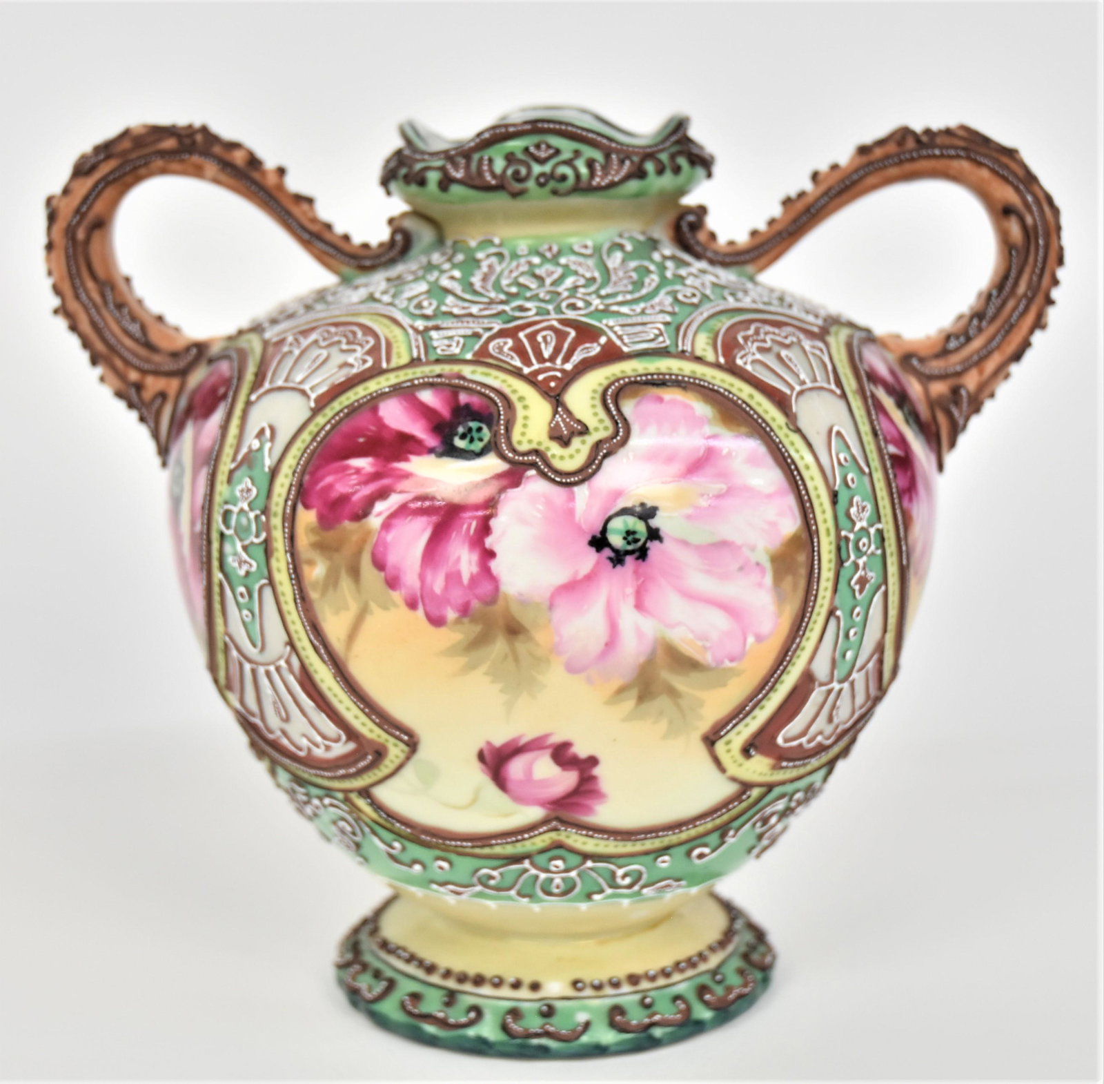 Nippon Moriage Handled Vase: With poppies. 7”T. 7 1/2” across handles. Highly intricate. Minor Moriage nicks. Otherwise, good condition. Unmarked.