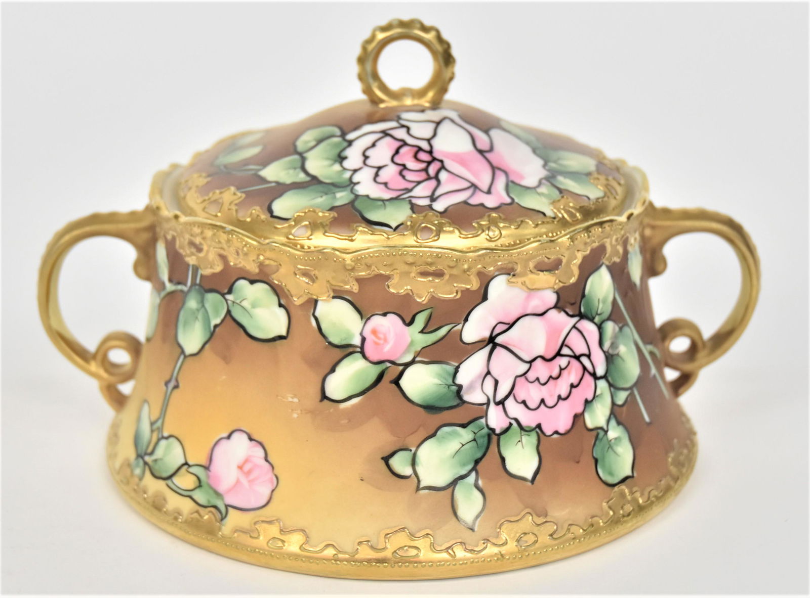 Nippon Cracker Barrel With Handles & Cover: Stylized roses. Decorative raised gold trim. 5”T With finial. 8” across handles. Very good condition. Blue mark.